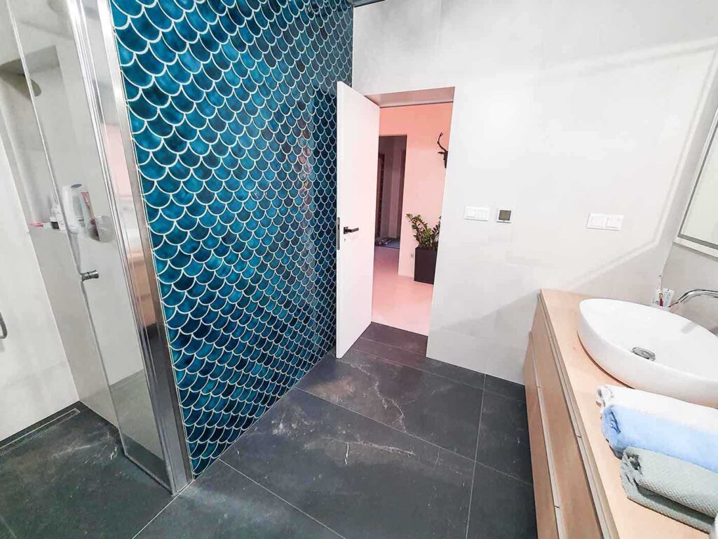 Ceramic mosaic tiles - fish scales, petrol blue color, bathroom wall