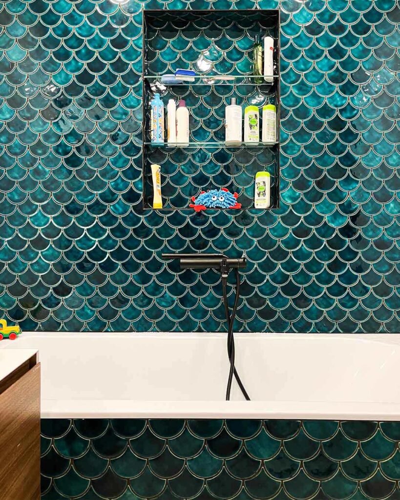 Ceramic mosaic tiles - fish scales, petrol blue color, bathroom wall above the bathtub