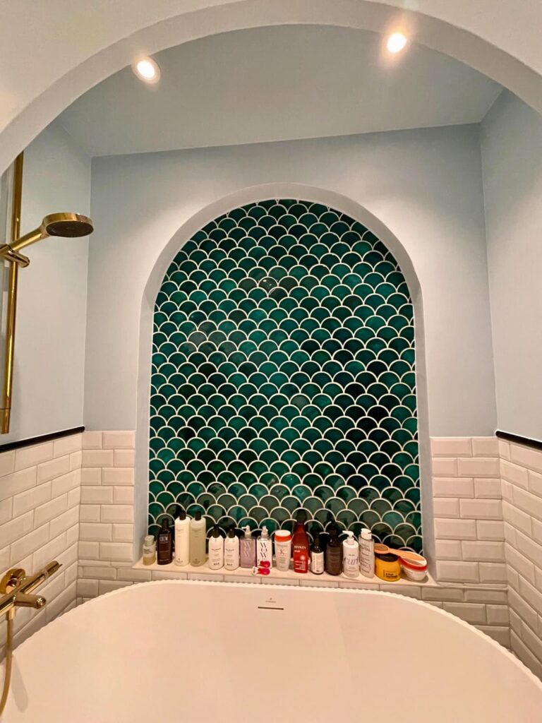 Ceramic mosaic - fish scales, blue green color, bathroom wall above the bathtub