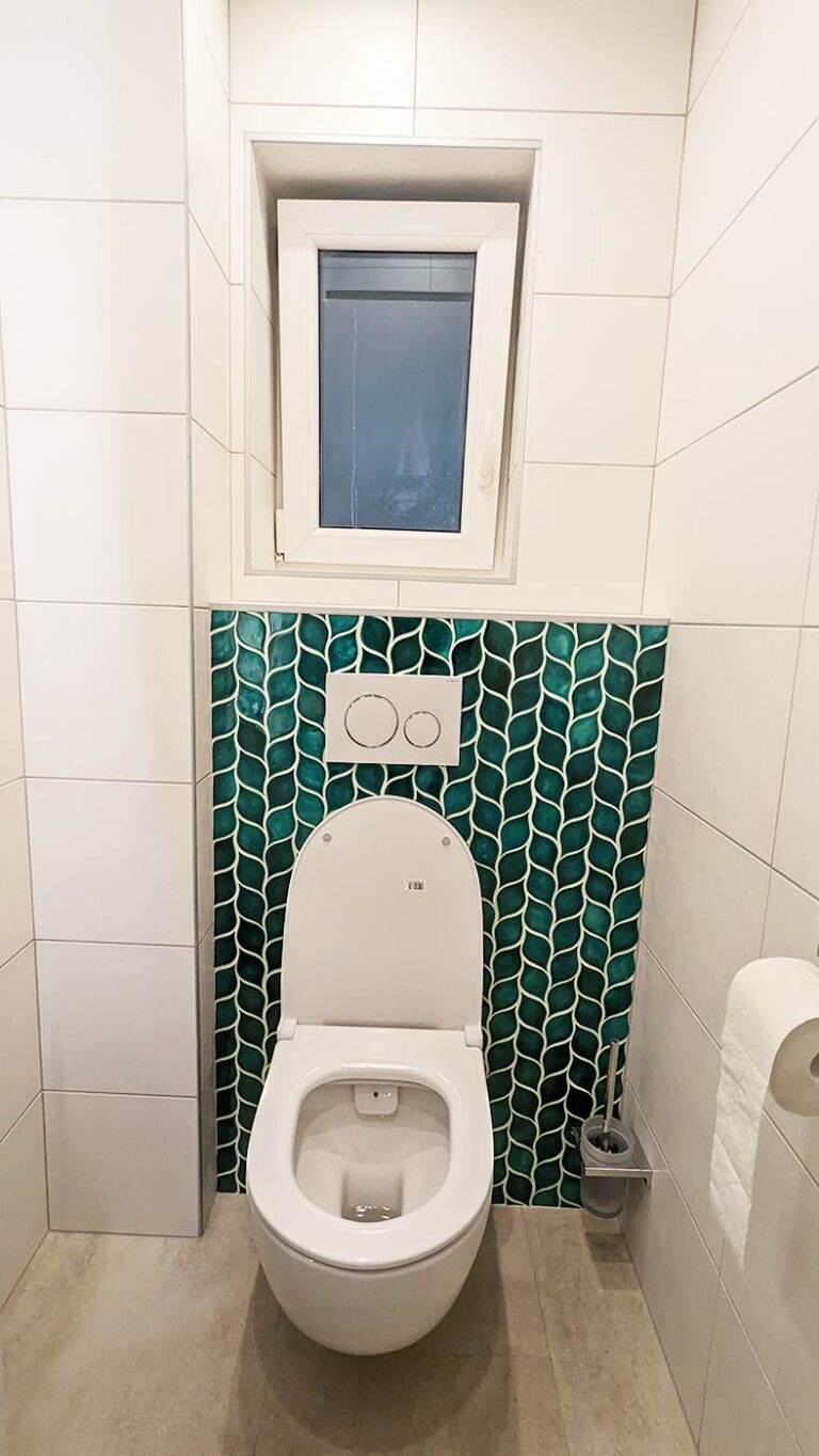 Ceramic mosaic tiles - leaves, blue green color, wall behind the toilet
