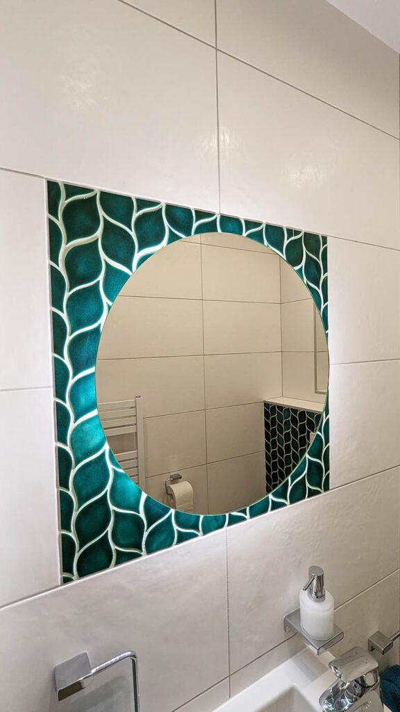 Ceramic mosaic tiles - leaves, blue green color, bathroom wall behind the mirror